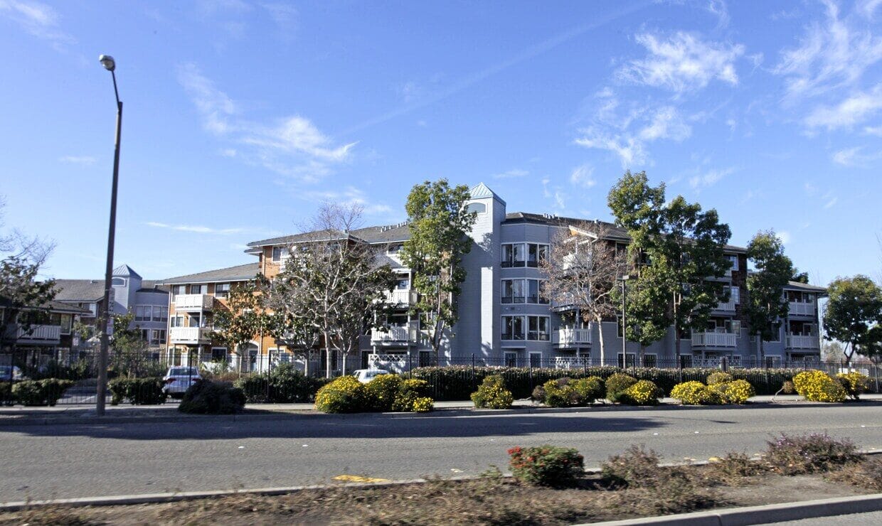 Exterior view of Independence Plaza facility with gardens