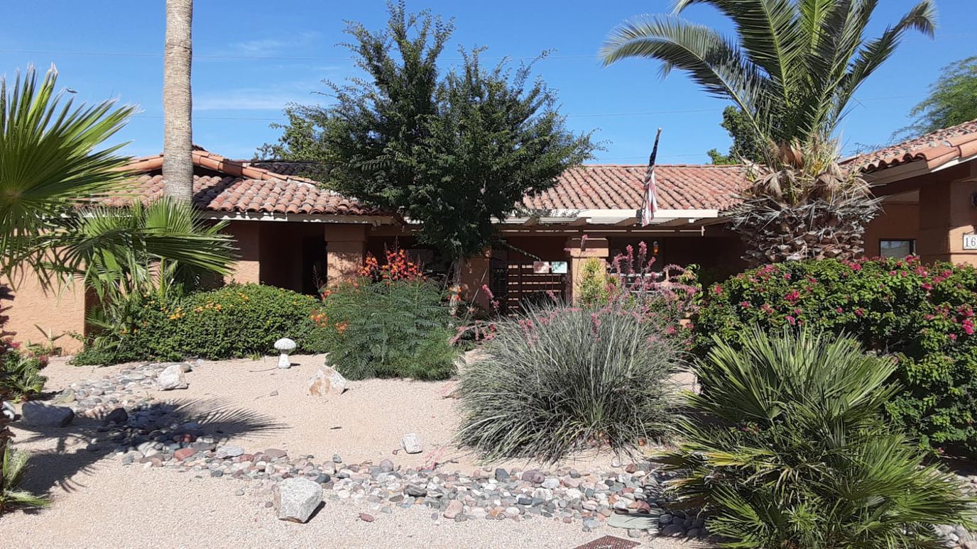 Beautiful exterior view of the assisted living facility's garden and entrance