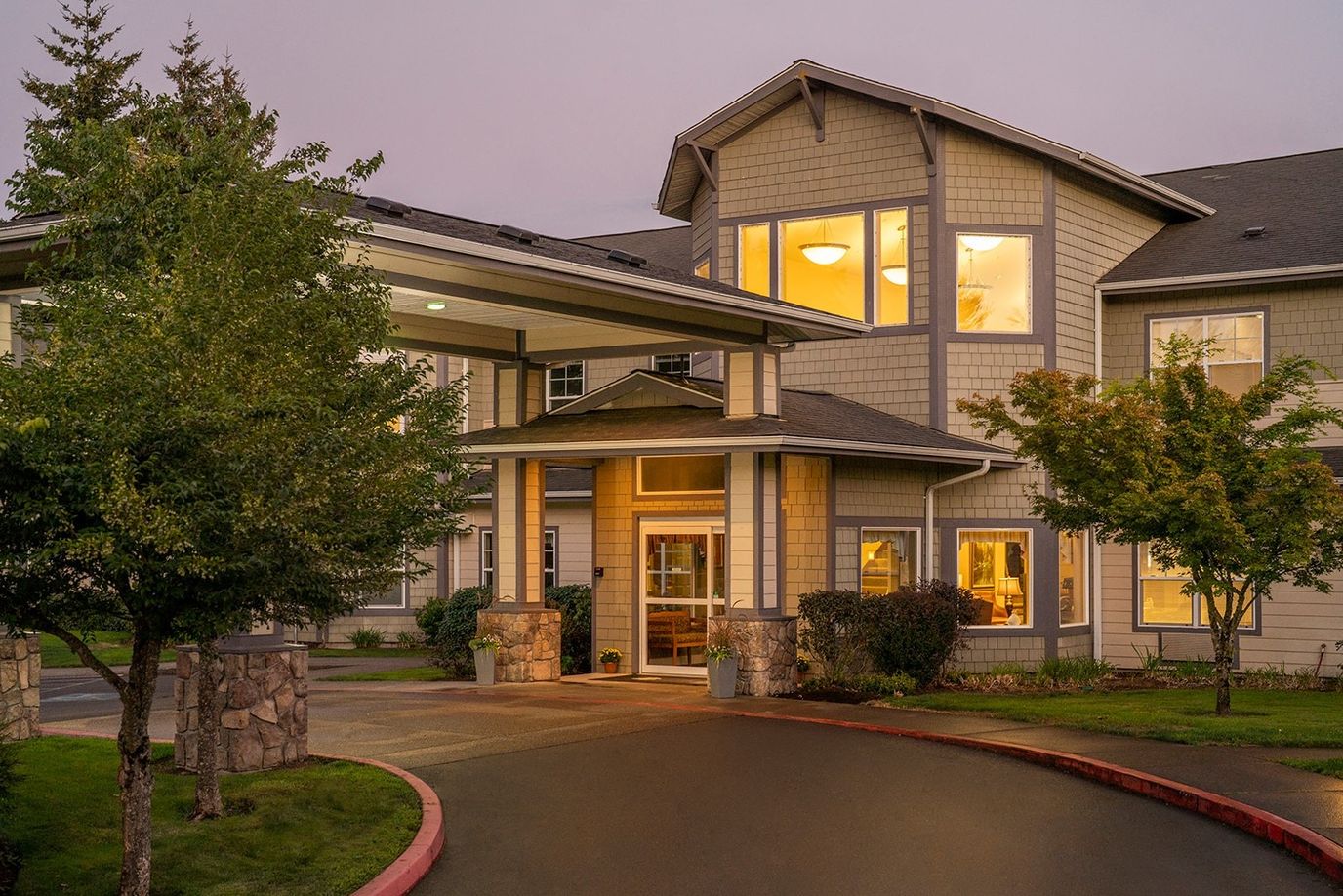 Entrance of Middlefield Oaks Senior Living with landscaped outdoor space