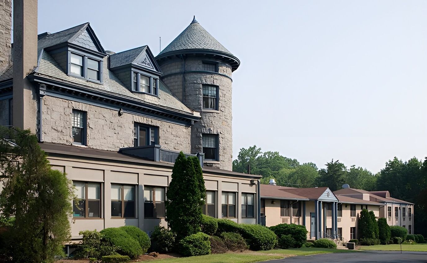 Exterior view of a nursing facility with landscaped gardens