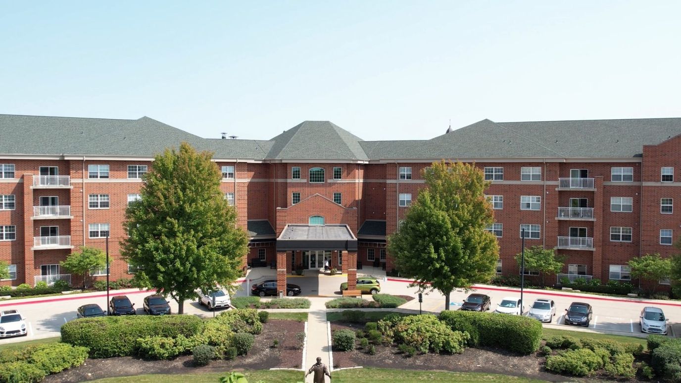 Exterior view of the facility with landscaped grounds
