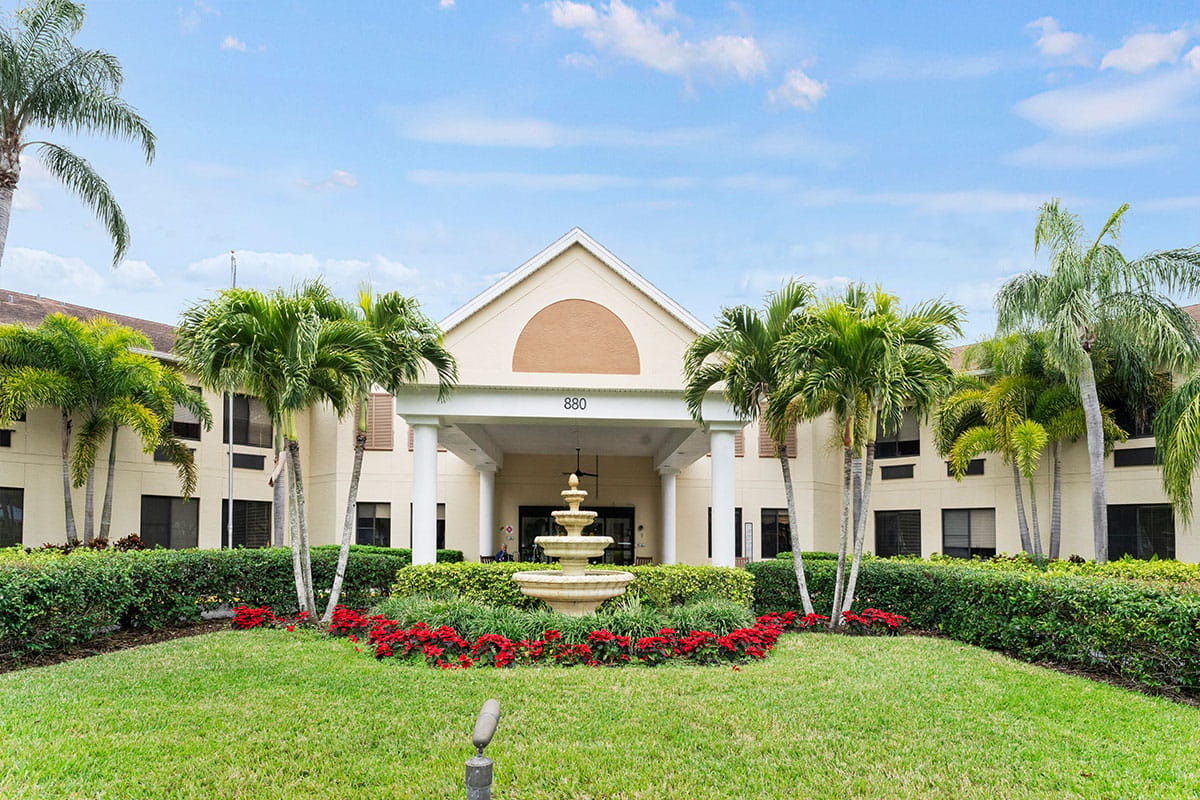 Exterior view of Volante Senior Living of Dunedin with fountain