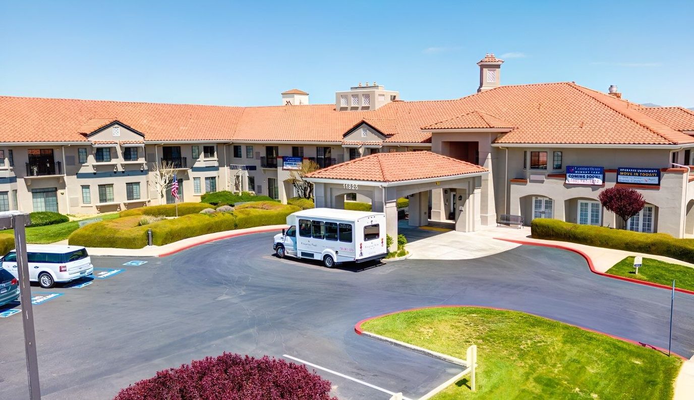 Exterior view of the facility entrance with a shuttle bus