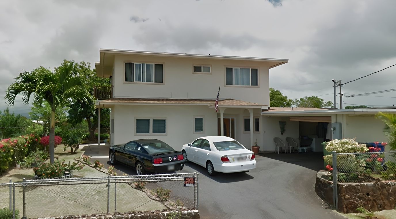 Exterior view of Aloha Nui Care Home with parking