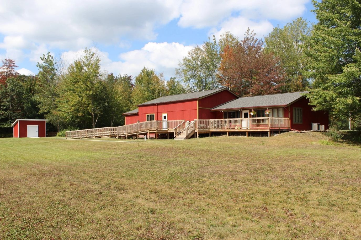 Exterior view of a red building surrounded by greenery