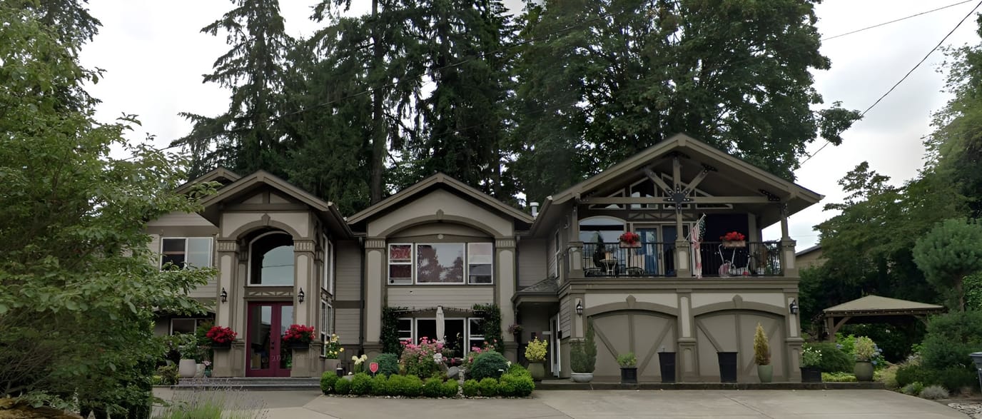 Exterior view of a senior care facility surrounded by trees