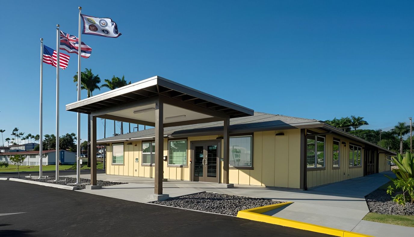 Exterior view of the facility building with flags