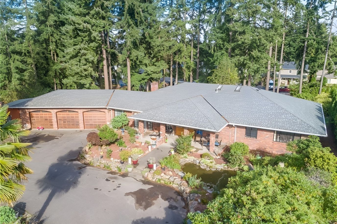Aerial view of Koi Castle Adult Family Home surrounded by trees