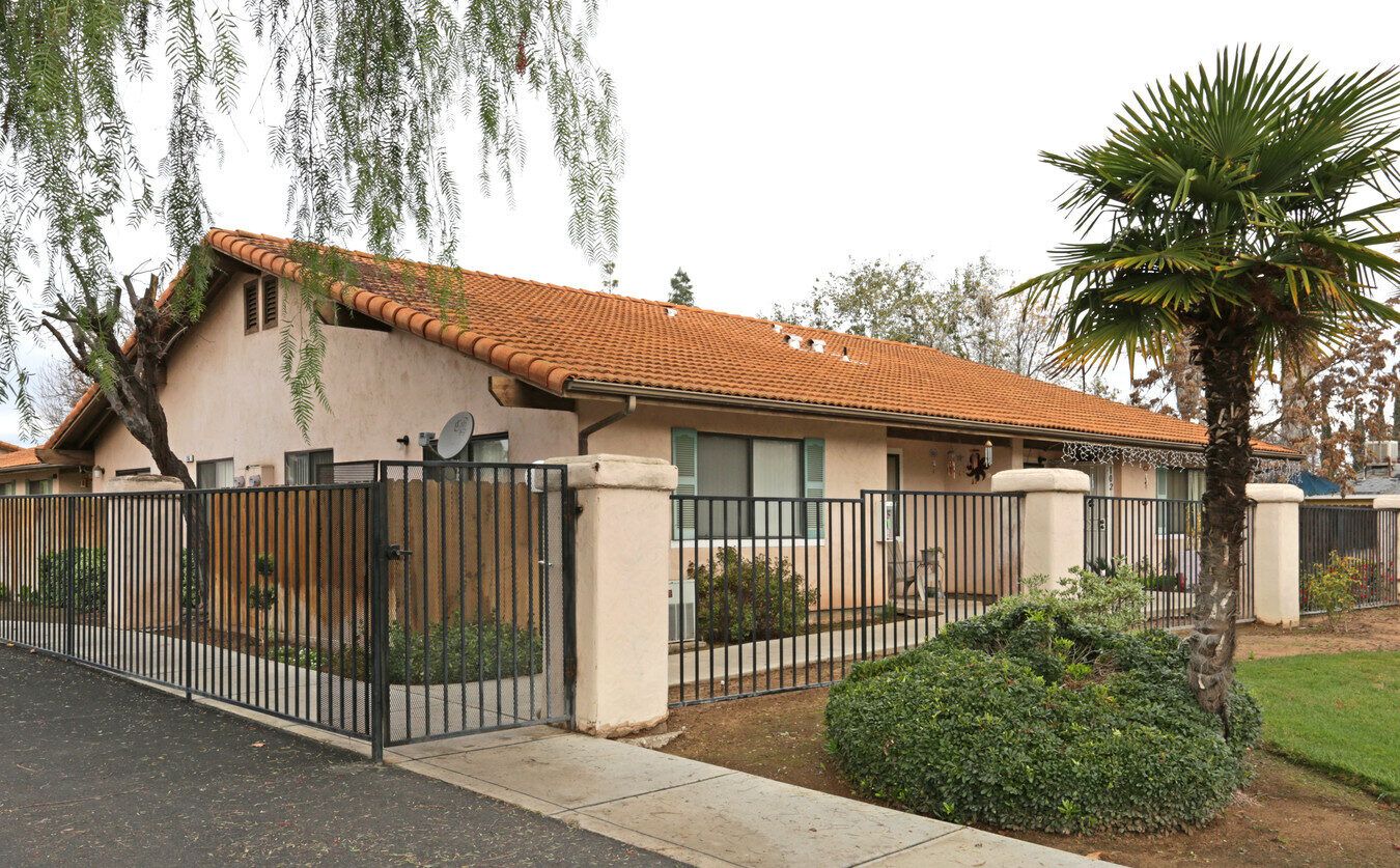 Exterior view of a retirement village with gates and landscaping