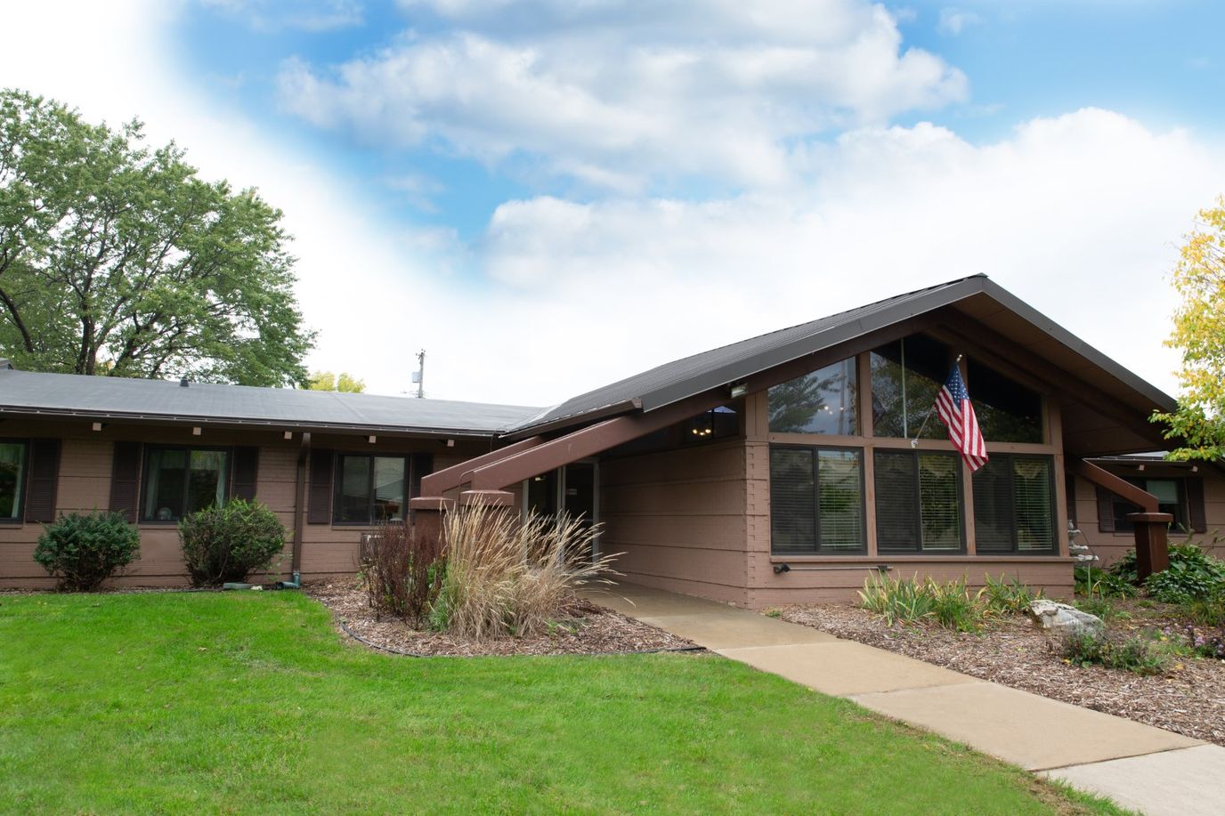 Exterior view of a senior living facility with landscaped grounds
