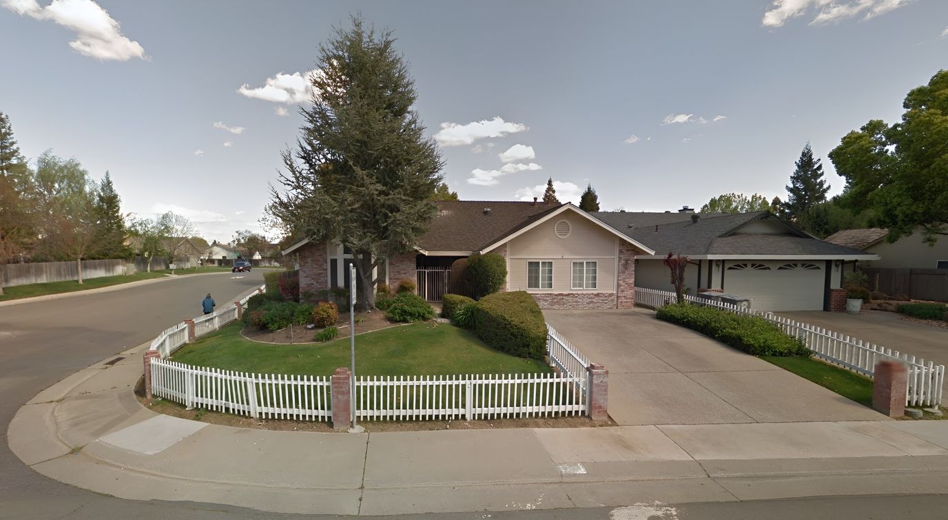 Exterior view of a senior care facility with landscaped front yard