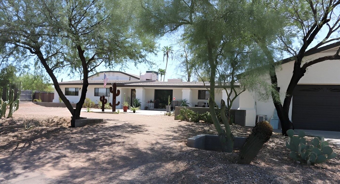 Exterior view of a senior living facility with desert landscaping