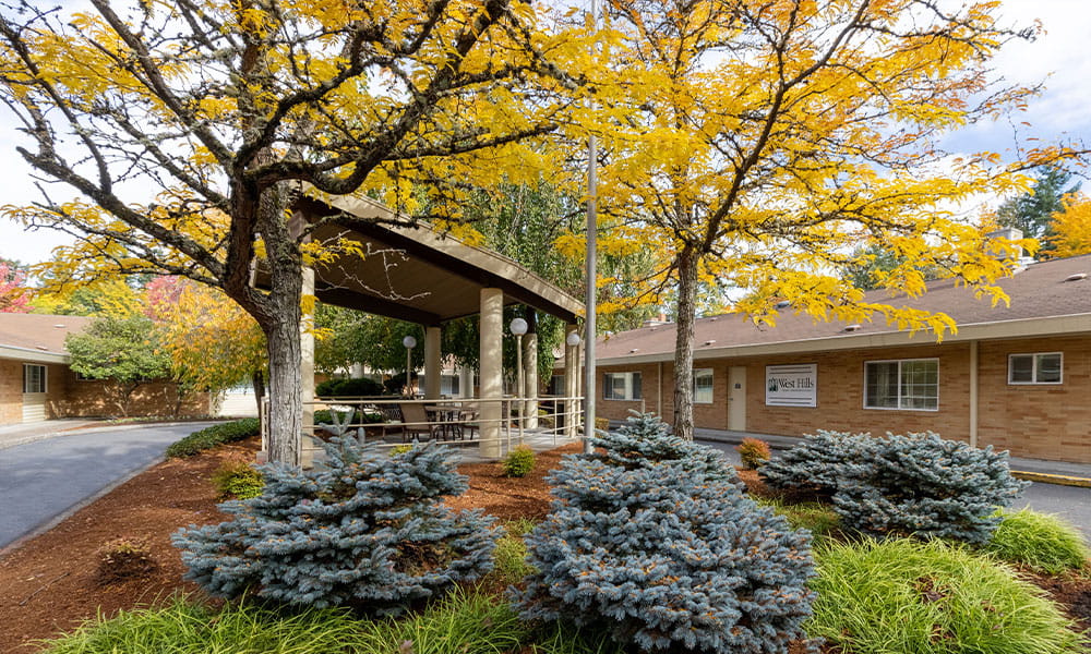 Outdoor view of the facility entrance with autumn trees