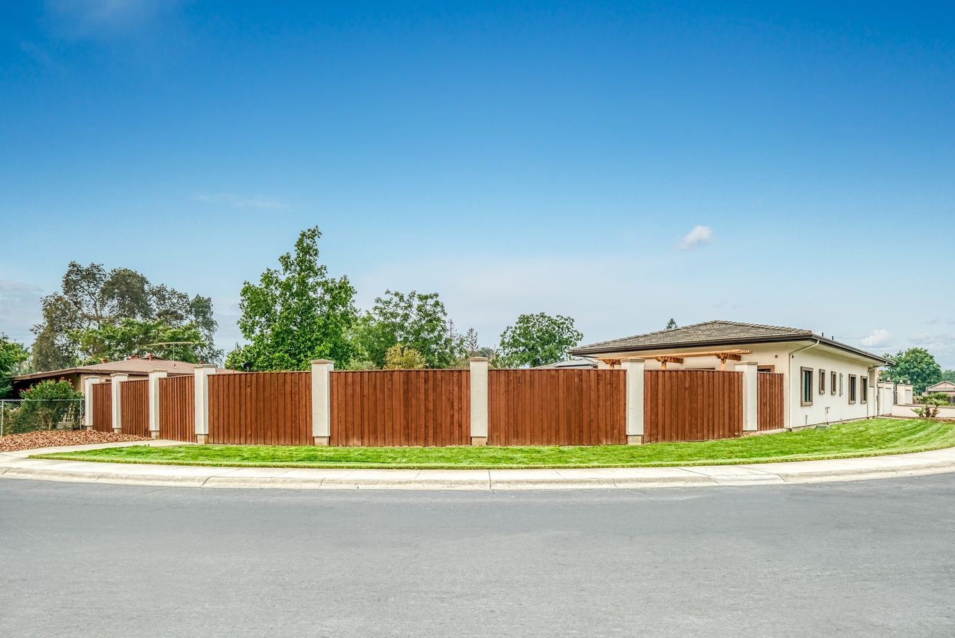 Exterior view of a nursing home facility with a wooden fence