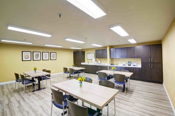 Bright common area with tables and flowers