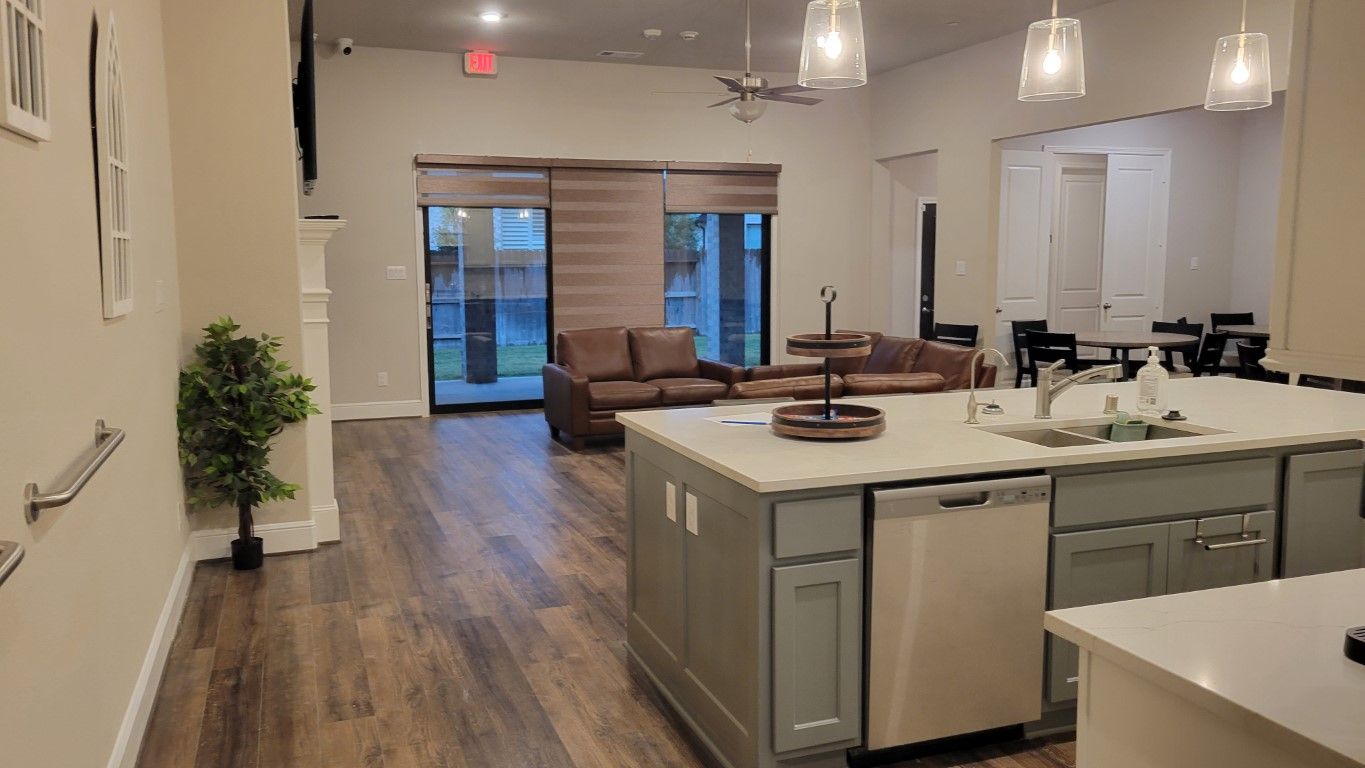 Bright common area with seating and kitchen view