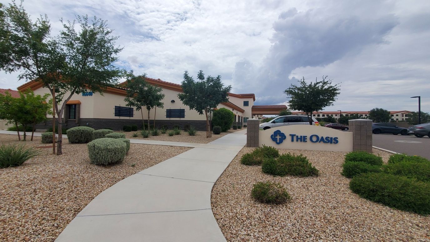 Exterior view of The Oasis facility entrance and landscaping