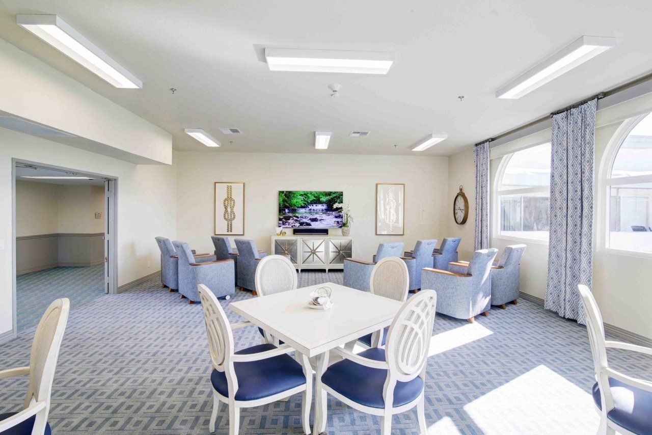 Common area with seating and television in a bright room