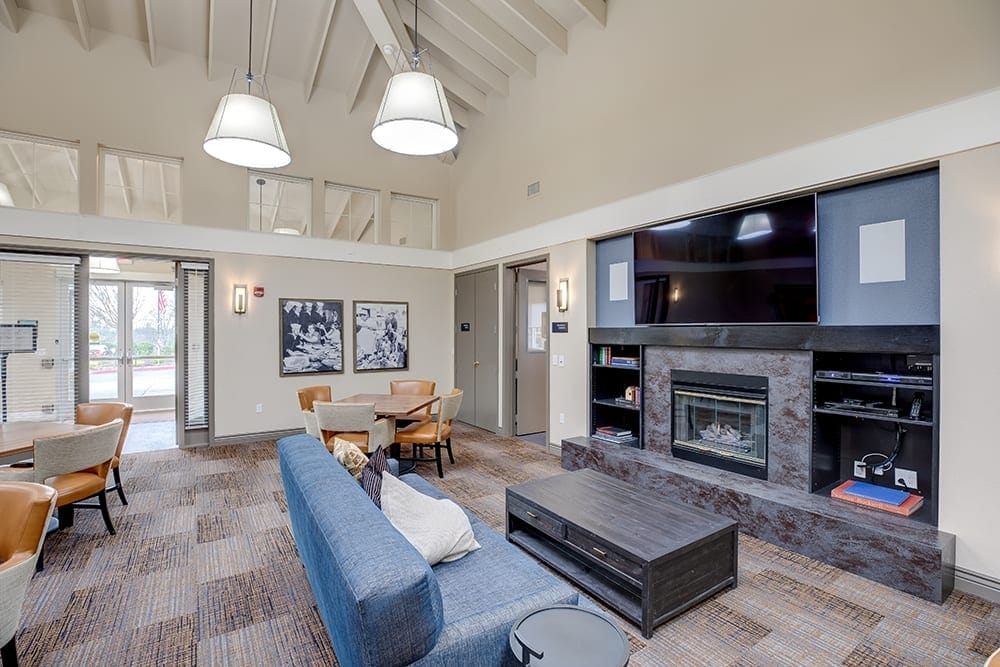 Spacious lobby lounge area with comfortable seating and a fireplace.