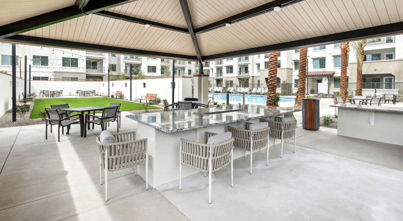 Outdoor space with seating and shade near the pool