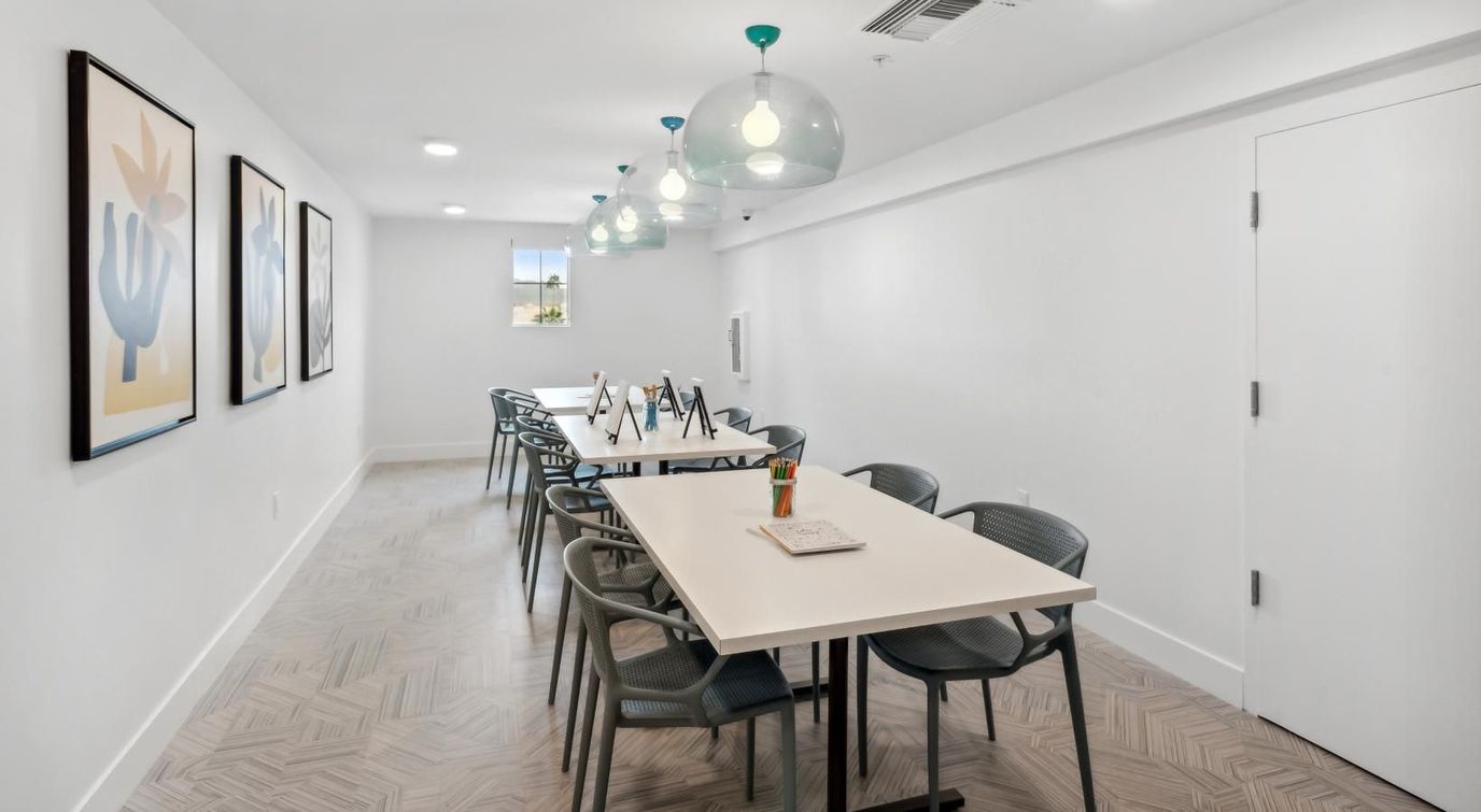 Bright common area with tables and artwork