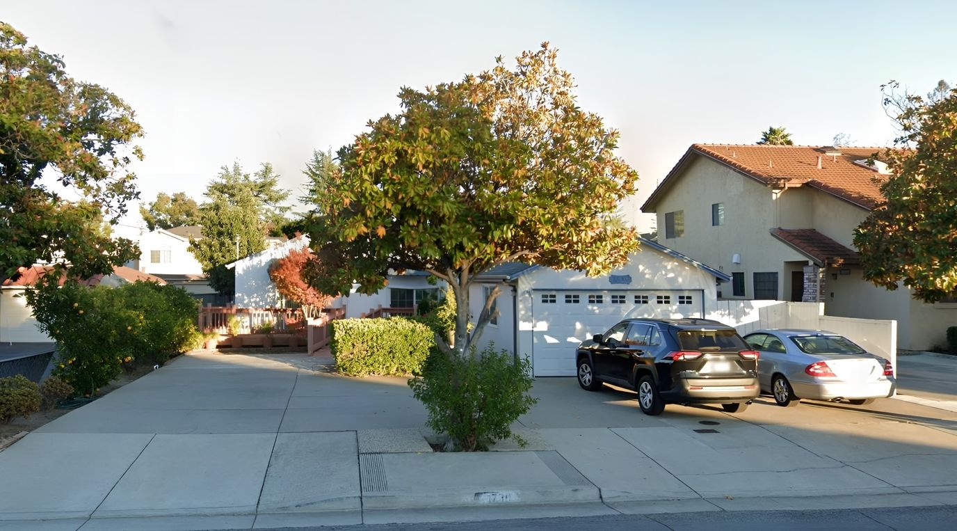 Exterior view of a residential care home with parking.