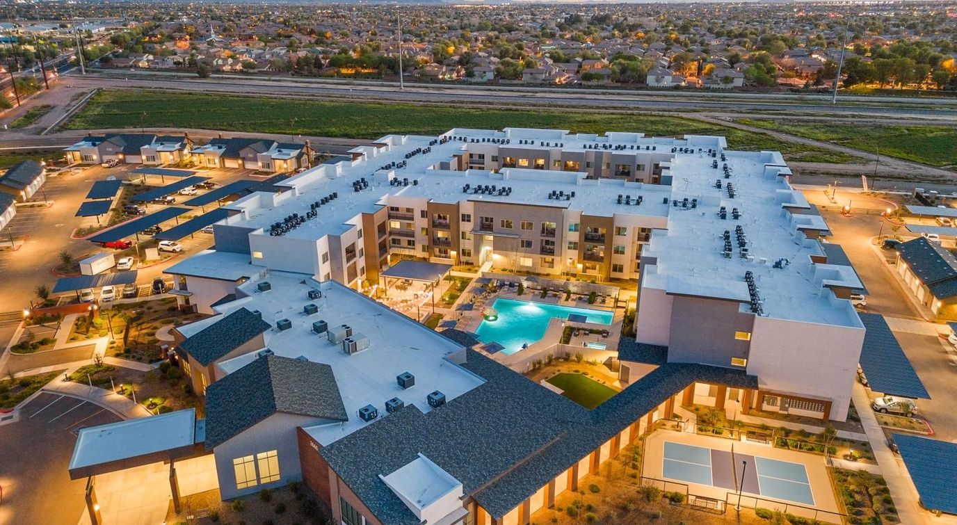 Aerial view of a senior living facility with pool and amenities