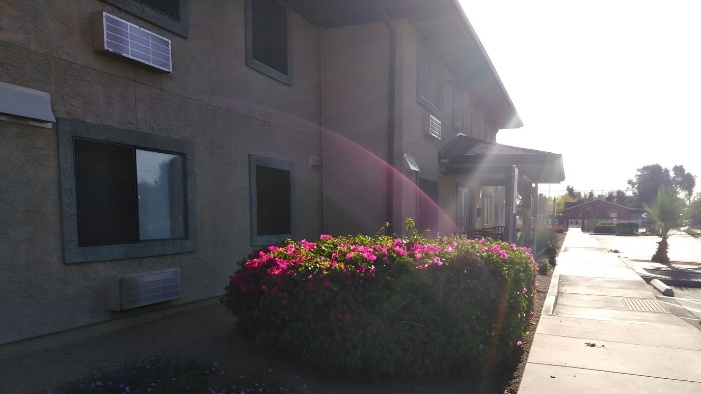 Exterior view of the facility with blooming flowers