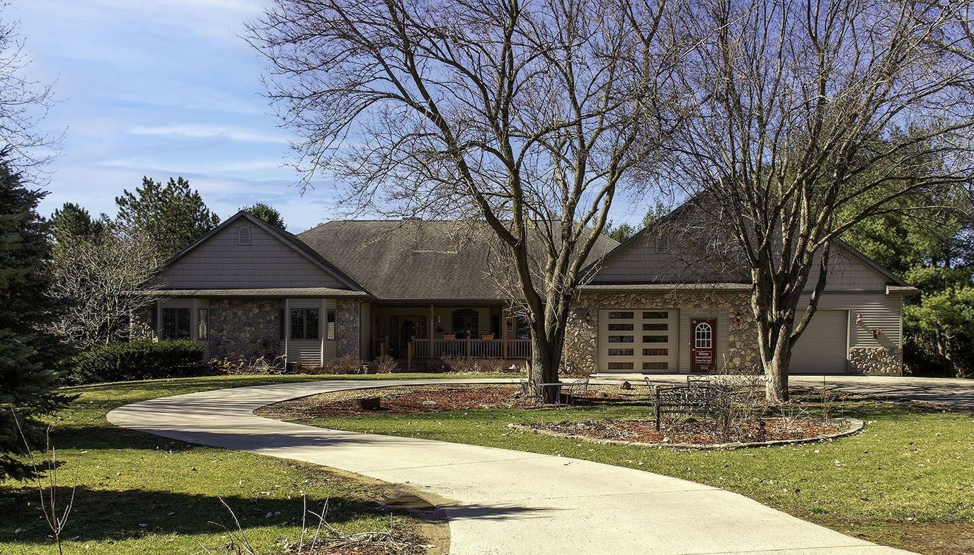 Outdoor view of a senior living facility surrounded by trees