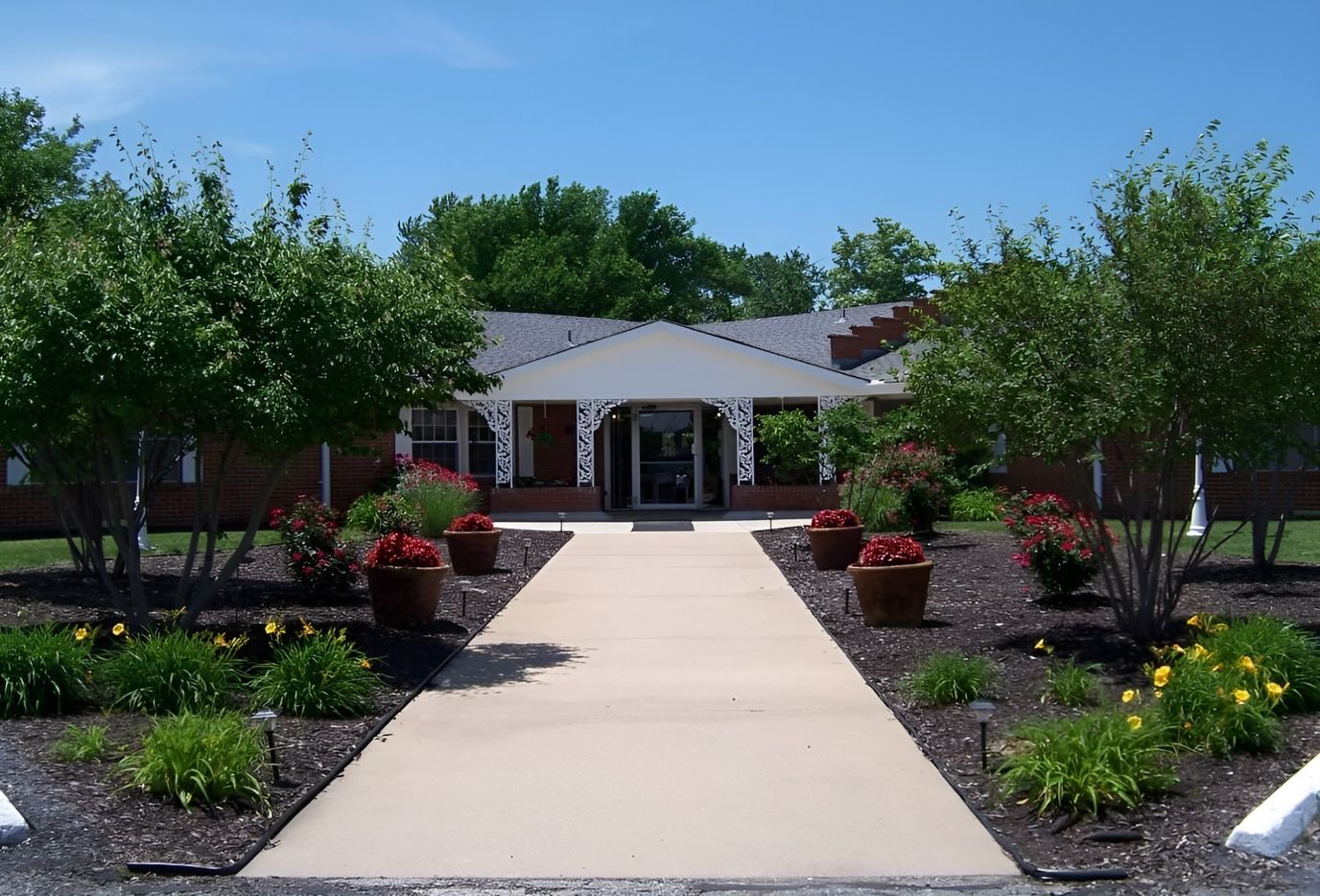 Front entrance of a senior living facility with landscaped grounds