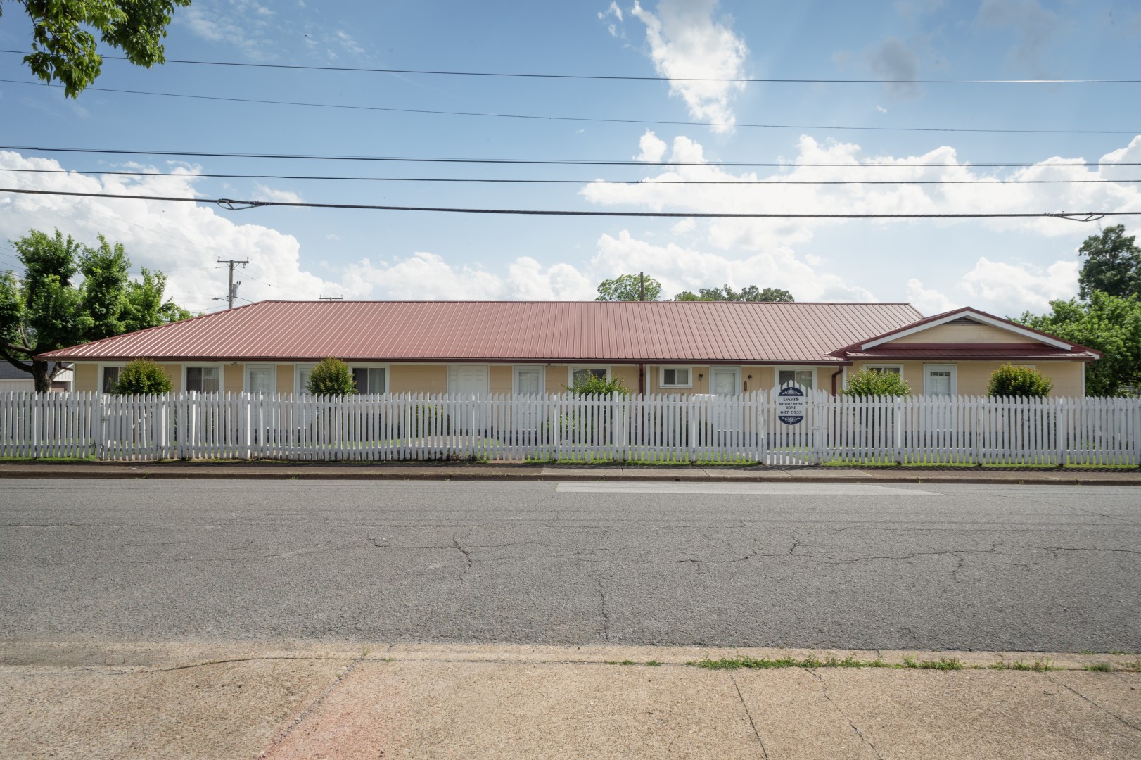 Exterior view of Davis Retirement Home with white picket fence