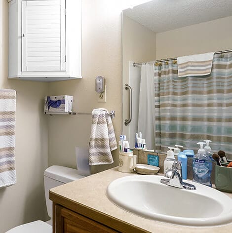 Brightly lit bathroom with toiletries and decor