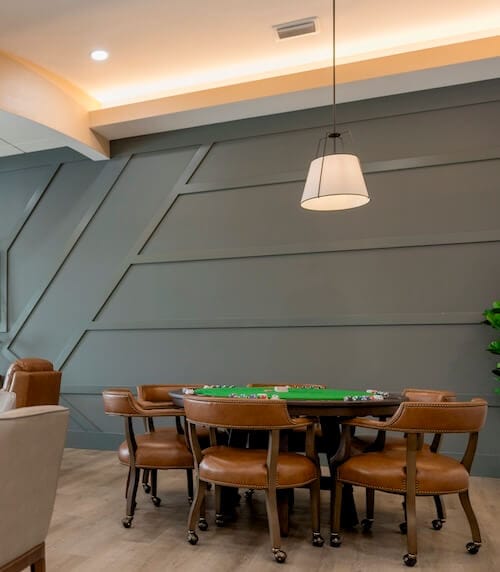 Interior activity room with poker table and chairs