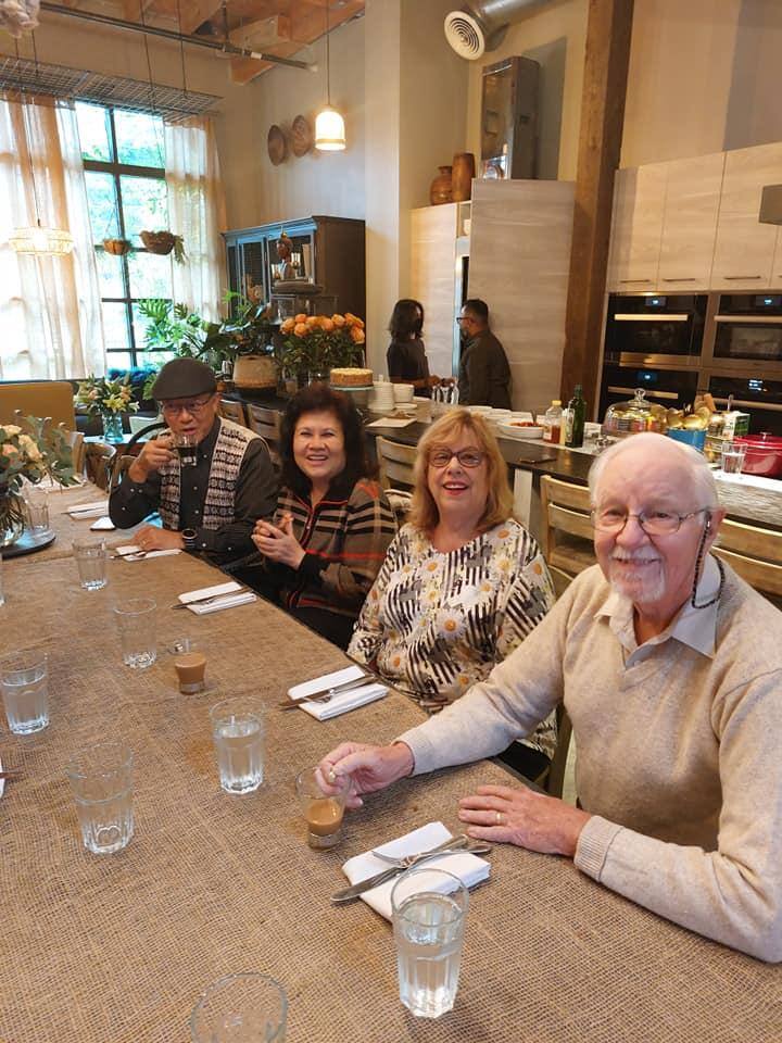 Residents seated at a dining table in a communal dining area