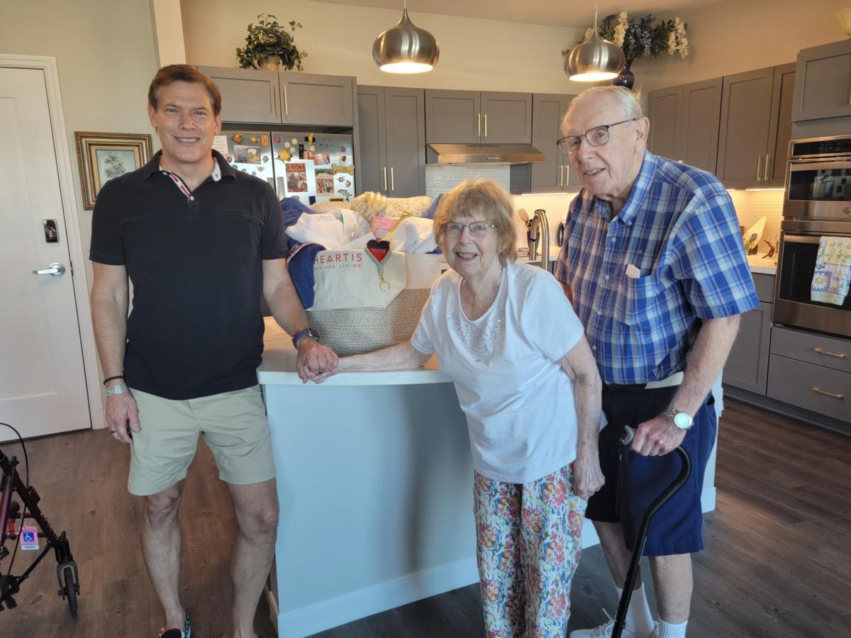Residents with staff in a bright kitchen area