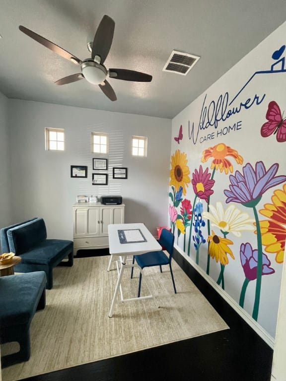 Bright interior of a room with colorful mural and furniture