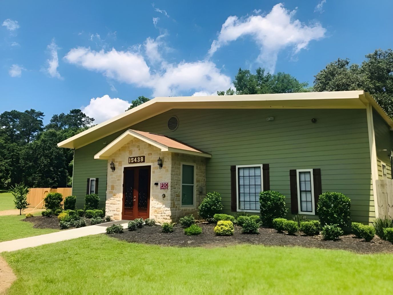 Exterior view of Countryside Manor building surrounded by greenery