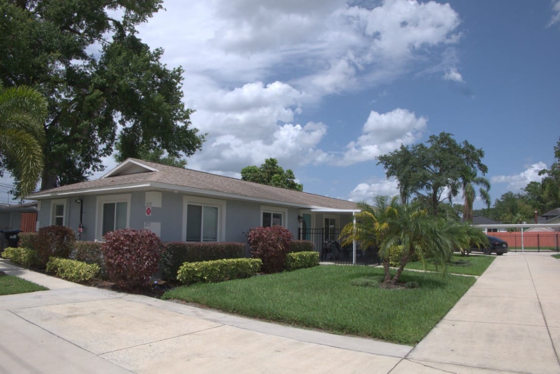 Exterior view of a senior living facility with gardens