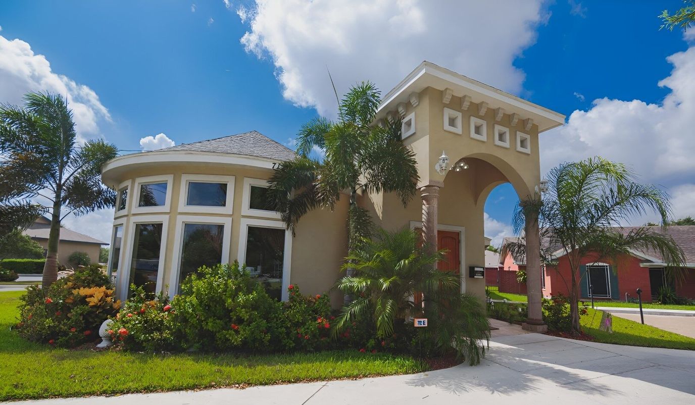 Exterior view of a senior living facility with gardens