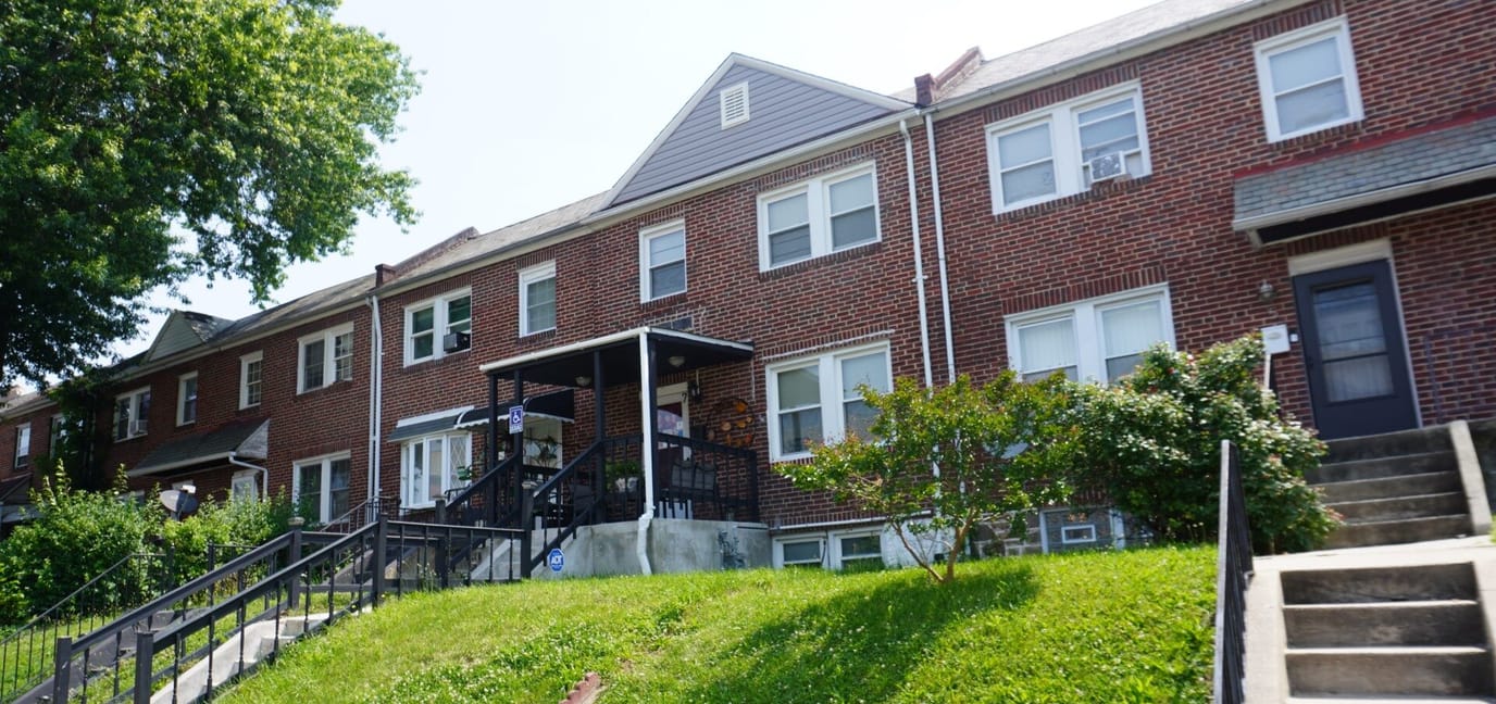 Exterior view of the assisted living facility with green lawn