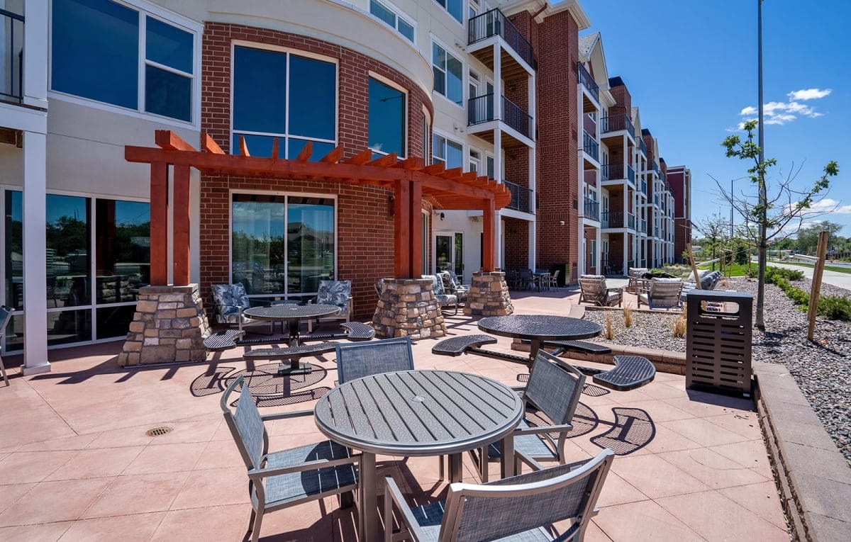 Outdoor seating area with tables and chairs at Heritage at Church Ranch