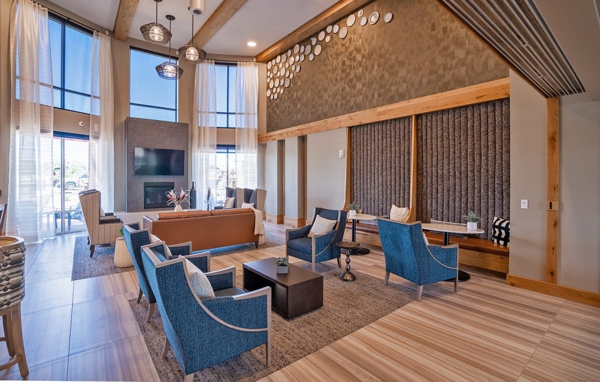 A cozy lounge area with comfortable seating and large windows.