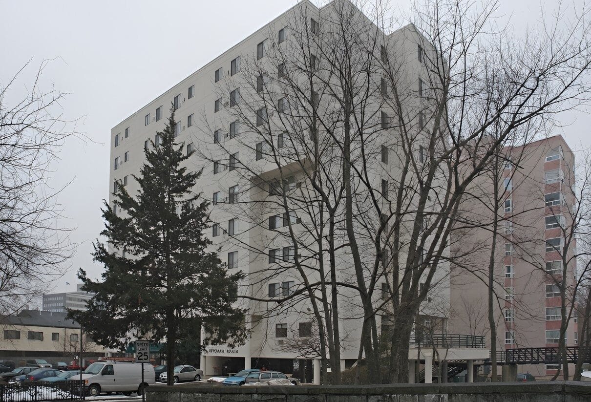 Exterior view of Rippowam Manor with trees and nearby buildings