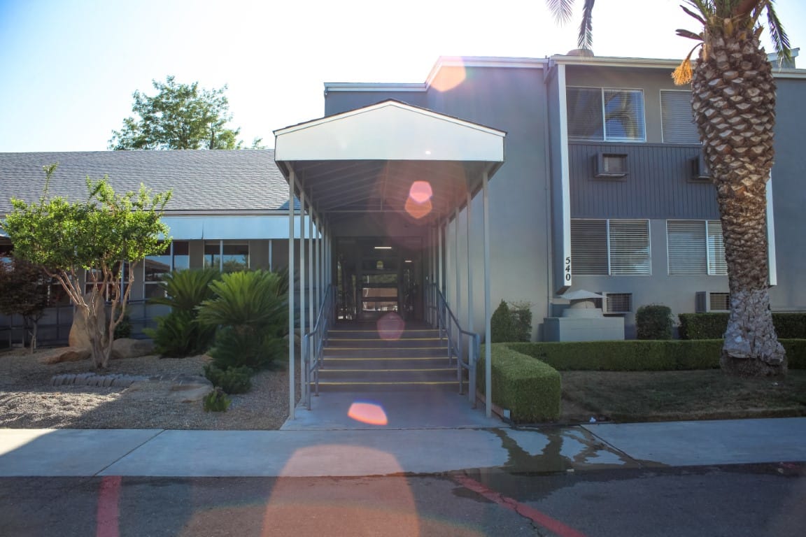 Accessible entrance with landscaped surroundings at Vintage Gardens