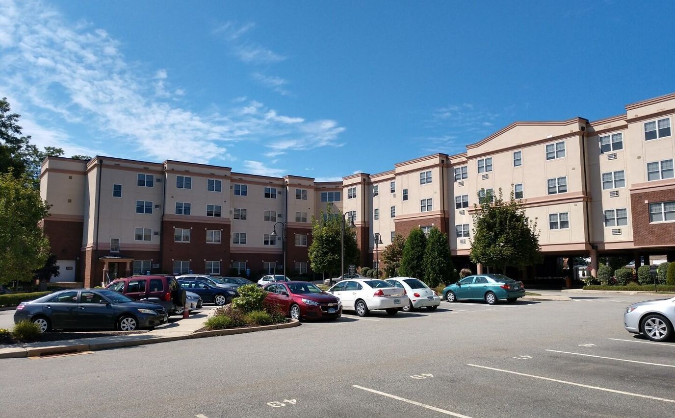 Exterior view of RiverView Apartments with parking area