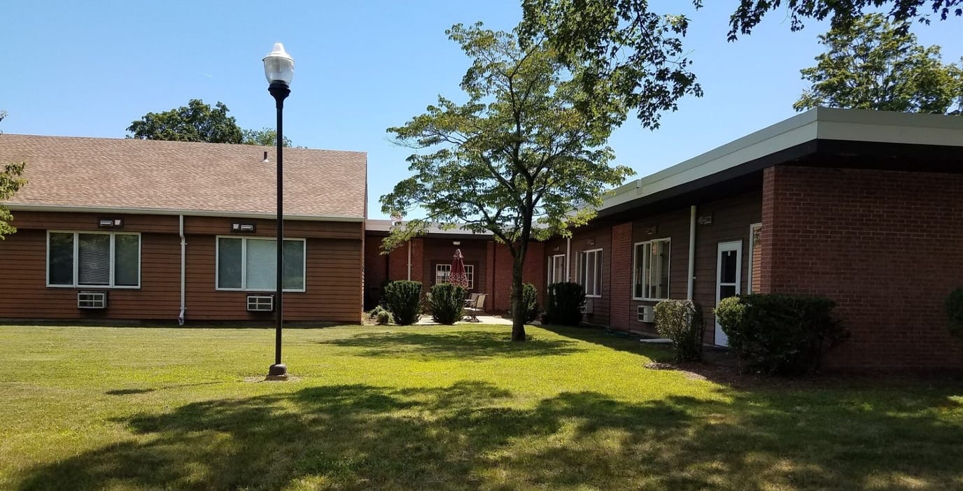 Exterior view of the assisted living facility with gardens