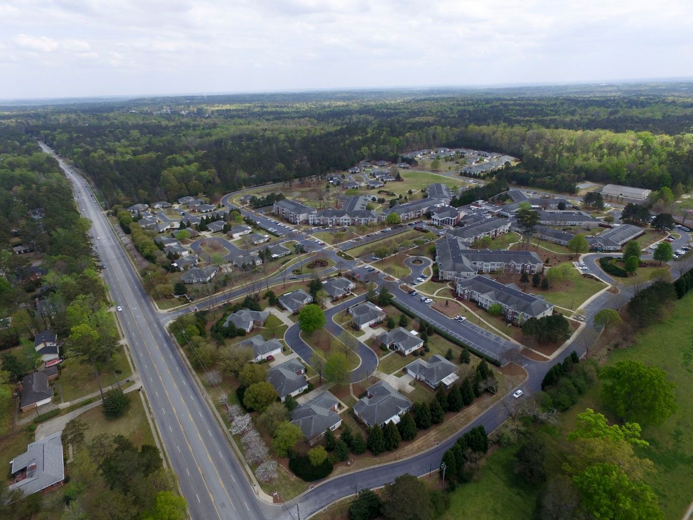 Aerial view of an assisted living community with green spaces