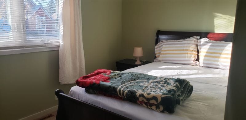 Cozy private resident room with bed and blankets