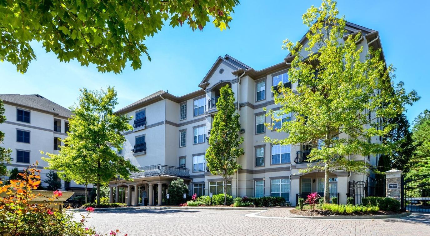 Exterior view of a senior living facility with landscaped areas