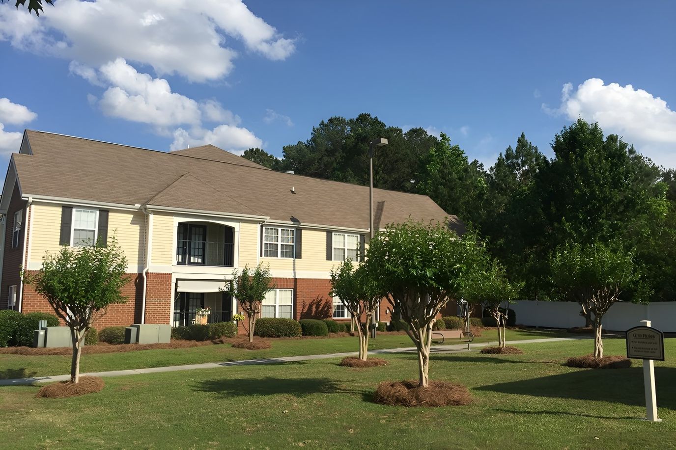 Exterior view of Ashton Meadows Apartments with landscaped grounds